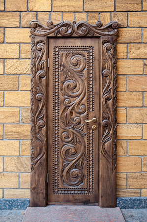 Old beautiful carved wooden doors in houseの写真素材