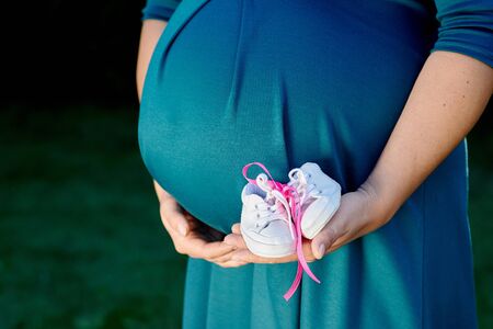 Image of pregnant woman touching her belly with hands.の写真素材