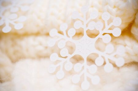 Christmas concept - Big white snowflake on white knitted scarf background.の写真素材