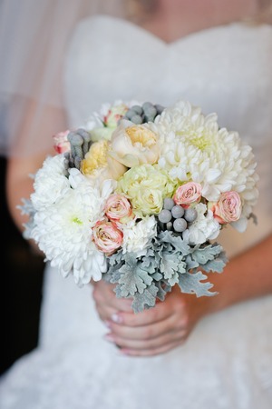 Bride holding beautiful wedding bouquetの写真素材