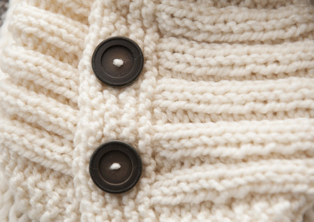 texture of white knitted soft sweater with buttons.の写真素材