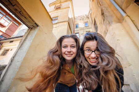Two happy women walking in old Lviv.の写真素材