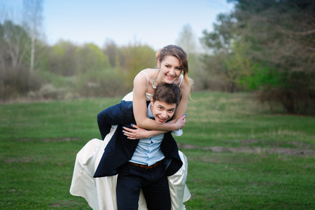 loving bride and groom walking in summer nature.の写真素材