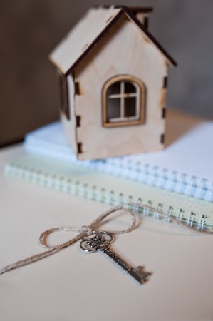 Conceptual image with small wooden house and keys.の写真素材