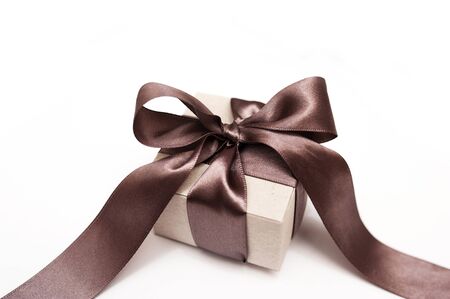 Gift box with brown bow on a white background.