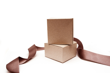 Gift boxes with brown ribbon on a white background.の写真素材