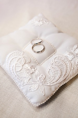 beautiful wedding rings on ring barer pillow.の写真素材