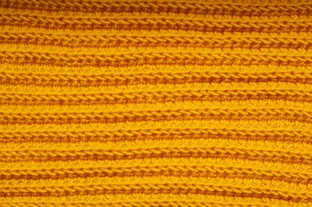 fabric orange knitted texture background with scarf clothing.の写真素材