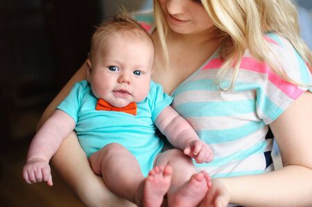 Beautiful young mother holds a little son.