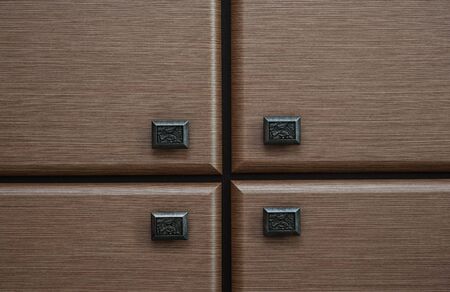 detail of four wooden drawers with metal handles.の写真素材