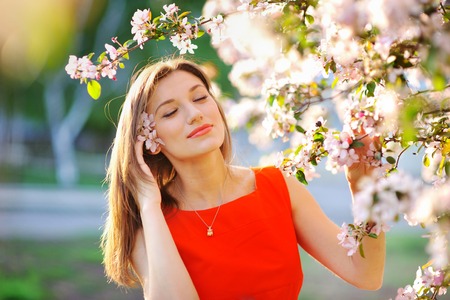 Beautiful woman with white flowering tree  in springの写真素材