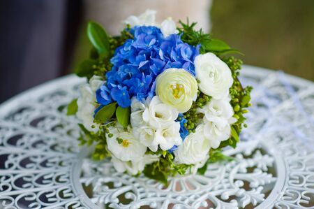 beautiful bouquet of bright blue and white flowers on  tableの写真素材