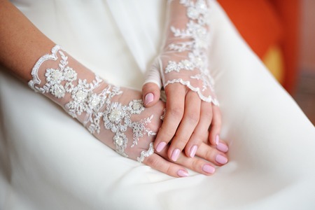 Wedding gloves on the hands of the brideの写真素材