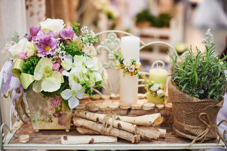 decor of candles and flowers at the wedding table in a restaurant.