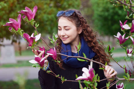 young beautiful woman in the blossoming spring garden.