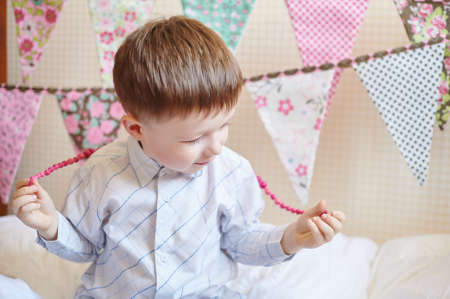 boy plays at the festival with flags on background.の写真素材