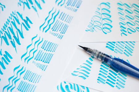 Hand drawn lettering background. Lettering waterbrush calligraphy on paper.の写真素材