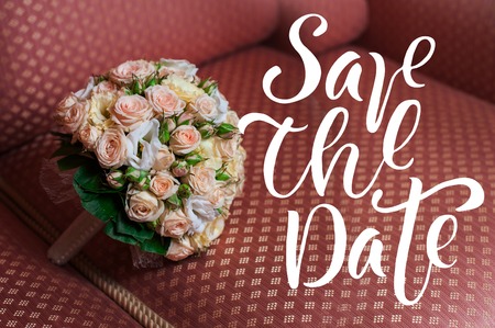 Beautiful wedding bouquet of roses lying on the sofa words save the data.の写真素材