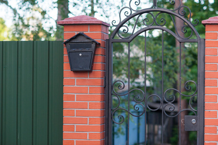 old mailbox fixed to the brick fence.の写真素材