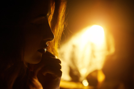 silhouette of a beautiful young woman backlit.