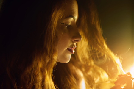 silhouette of a beautiful young woman backlit.