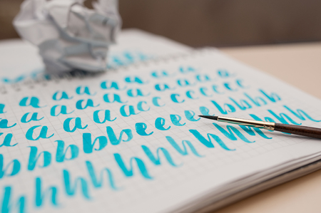 Notebook with calligraphy Lettering and brush. Hand drawn typography.の写真素材