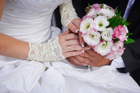 Beautiful wedding bouquet in brides and grooms hands.