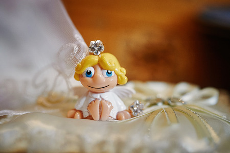 little toy Angel on a pillow for wedding rings.の写真素材