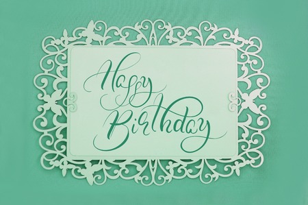 greeting card with text Happy Birthday on green background. Calligraphy lettering.の写真素材