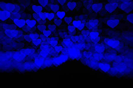 abstract black background with soft blue hearts.の写真素材