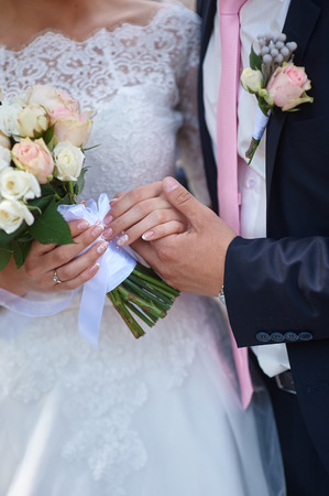 groom holding brides hand at the wedding walk.の写真素材