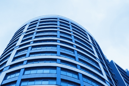 blue glass office building skyscraper on background of skylineの写真素材