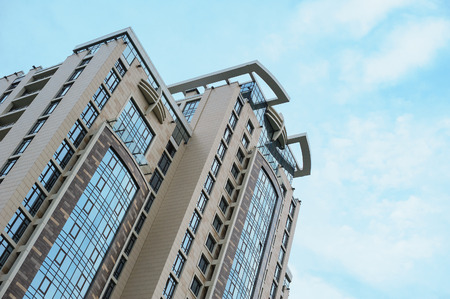 Multistorey apartment house on the sky background