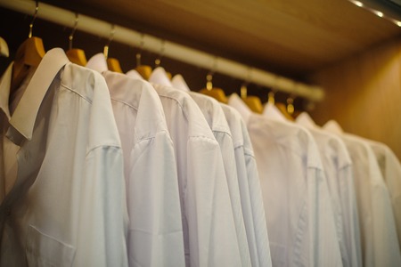 background of row white shirt hangingの写真素材