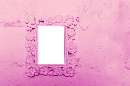 Photo frame on the pink wall with space for textの写真素材