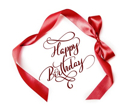 brown ribbon with a bow on white background and text Happy Birthday. Calligraphy letteringの写真素材