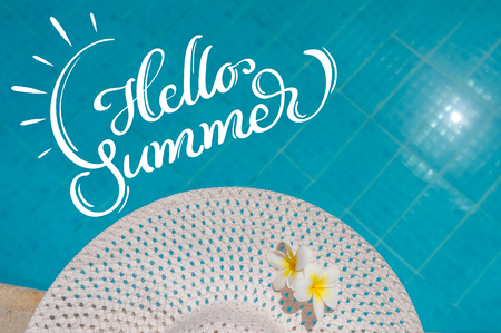 great white female hat near the pool and text Hello Summer. Calligraphy letteringの写真素材