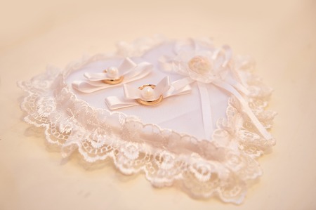 White pillow for rings in the shape of heartの写真素材