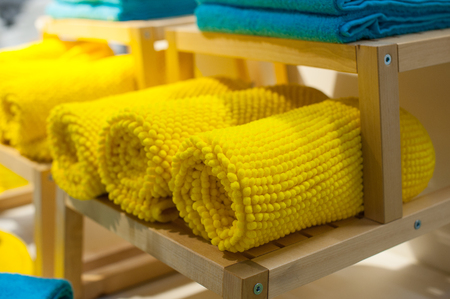 yellow towels on the shelf in the closetの写真素材