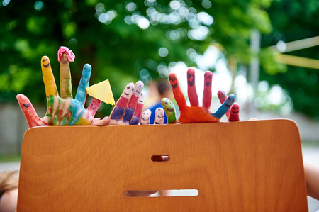 Childrens multicolored paints colored fingersの写真素材