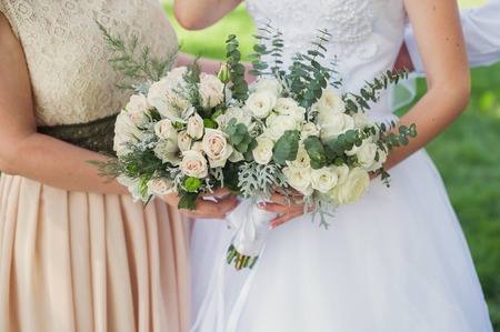 Bride and bridesmaid with bouquetsの写真素材
