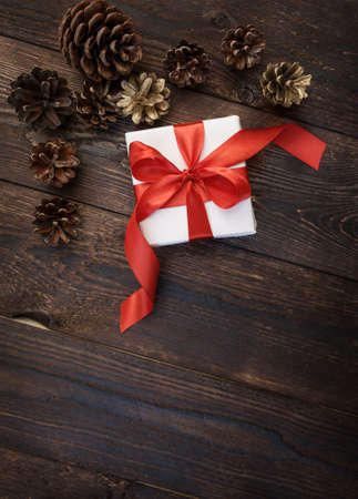 gift box with red ribbon on a wooden backgroundの写真素材