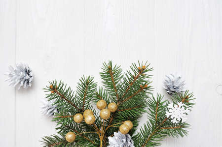 Mockup Christmas tree branch flatlay on a white wooden background, with place for your text.