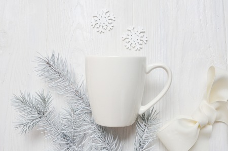 Mockup white cup on a wooden background, in Christmas decorations. The top view is photographedの写真素材