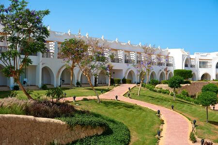Sharm el-Sheikh, Egypt - April 15, 2018. The courtyards of a magnificent white hotel on a summer day. The concept of tourism, vacations and luxury recreation. Accommodation in Cyrene Grand Hotelのeditorial素材