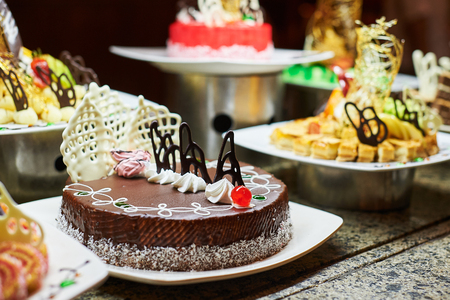 Sweets on banquet table - picture taken during catering event. Rows of tasty looking desserts in beautiful arrangementsの写真素材