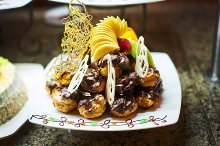 Sweets on banquet table - picture taken during catering event. Rows of tasty looking desserts in...