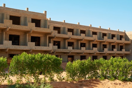 Construction of new modern residential building, workers pour concrete in wooden frameworkの写真素材