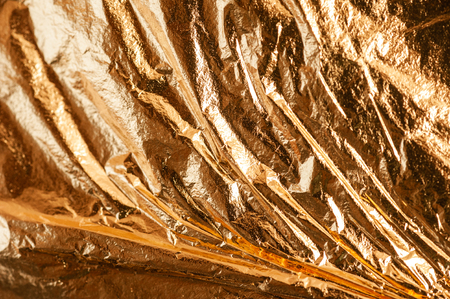 rumpled golden glitter abstract background, potal for gilding items with place for textの写真素材