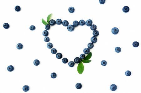 Summer blueberry heart frame detox isolated on white background. Love berries border design. Close up top view or flat lay with place for your textの写真素材